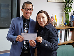 (left to right) Central West Region BSC Business Loan Counselor Phuong Le presenting Jean Kwon, owner of JK Law Firm, with a $100,000 SBA working capital loan