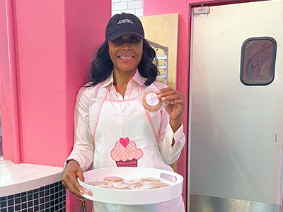 Angella Cole, owner of Angella's Sweet Spot, with a tray of baked treats