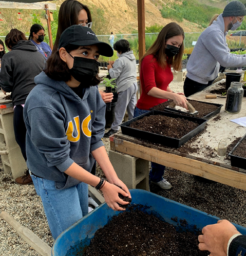 Boyle Heights YSC participant Alexandra Granados learning about soil management during her intership with North East Trees Nursery