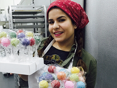Lerida Mojica, owner of NY Cake Pops, displays a fresh batch of multi-colored cake pops
