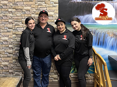 Owner of Sam's Kebabs, Samvel Dumanyan (second from left) poses with his wife and two daughters inside his Van Nuys restaurant location