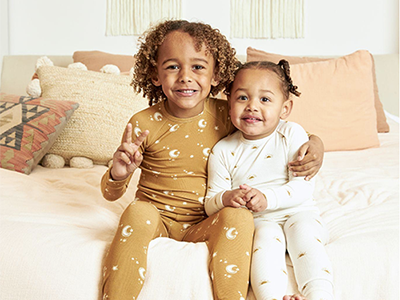 two happy young children dressed in Rosewood the Label brand eco friendly cotton pajamas