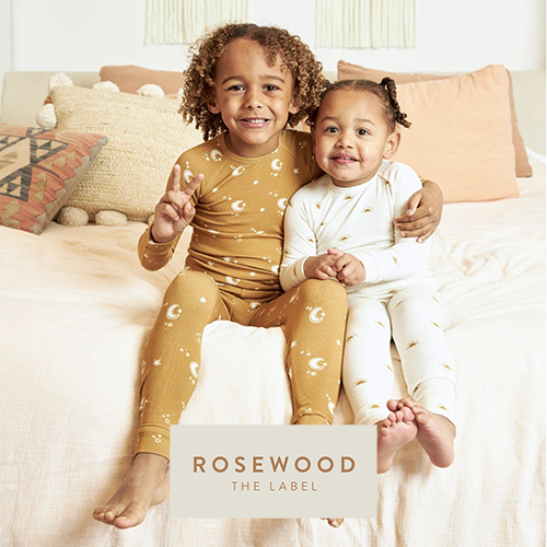 two happy young children dressed in Rosewood the Label brand eco friendly cotton pajamas