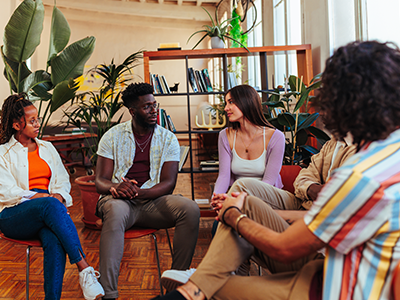 Stock image of a group counseling session comprised of young adults