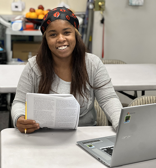 Ebony Mckinney, LA:RISE Youth Academy participant, studying between her Central City Neighborhood Partners intern shifts