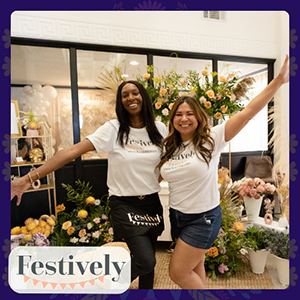 Patty Flores and Iris Hosea, co-founders of Festively, pose in their shop surrounded by flowers