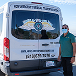 Armando Miranda, owner of Angels of Hope Med Trans, beside his non-emergency medical transport van