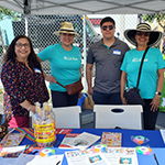 (far left) East LA BSC Program Director Irma Vargas and (second from right) Pico-Union BSC Business and Loan Counselor Ivan Vasquez pose with Bella Entreprenuers staff members at The Goddess Mercado BELLA Takeover event during the Small Business Resource Expo on Saturday, May 14, 2022, in the East LA Hilda Solis Learning Academy parking lot